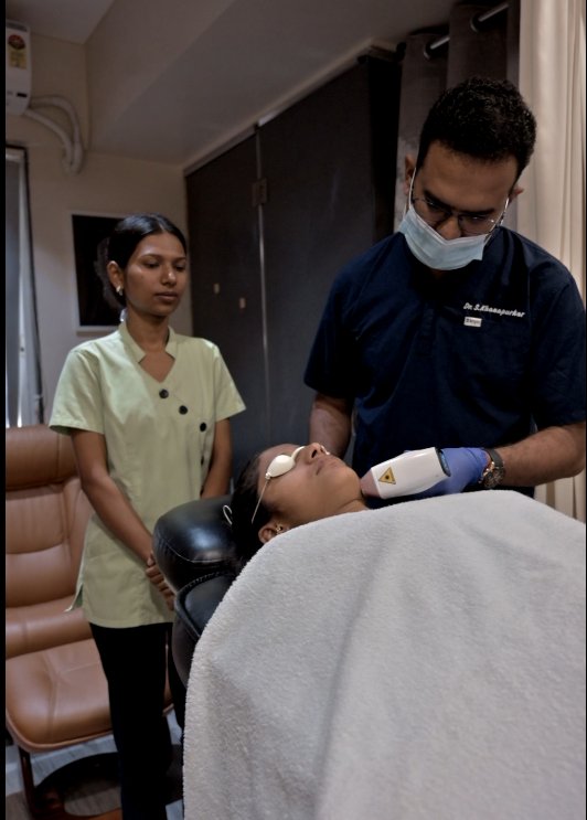 Laser treatment being performed with a trained assistant present